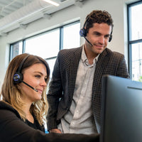 Office workings using LH570 wireless headset while training at computer